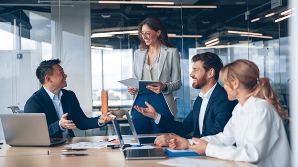 Image depicts HR professionals discussing absence management software