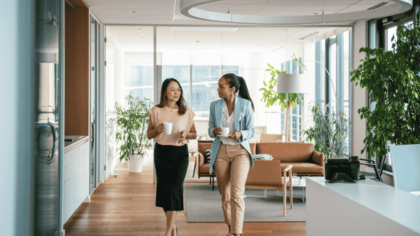 Image depicts two finance colleagues discussing invoice pay and ap automation