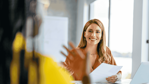 Image depicts an payroll professional discussing their payroll administration