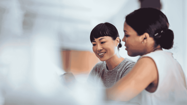 Image depicts two coworkers discussing the advantages of premium ap 