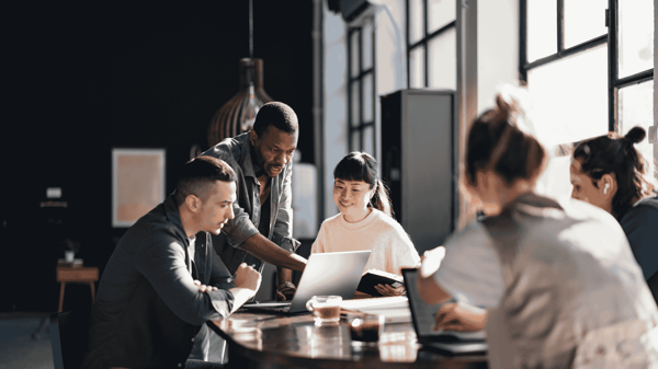 Image depicts a team discussing Workday ERP