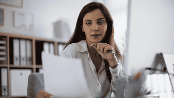 Image depicts an HR leader evaluating Workday Compensation