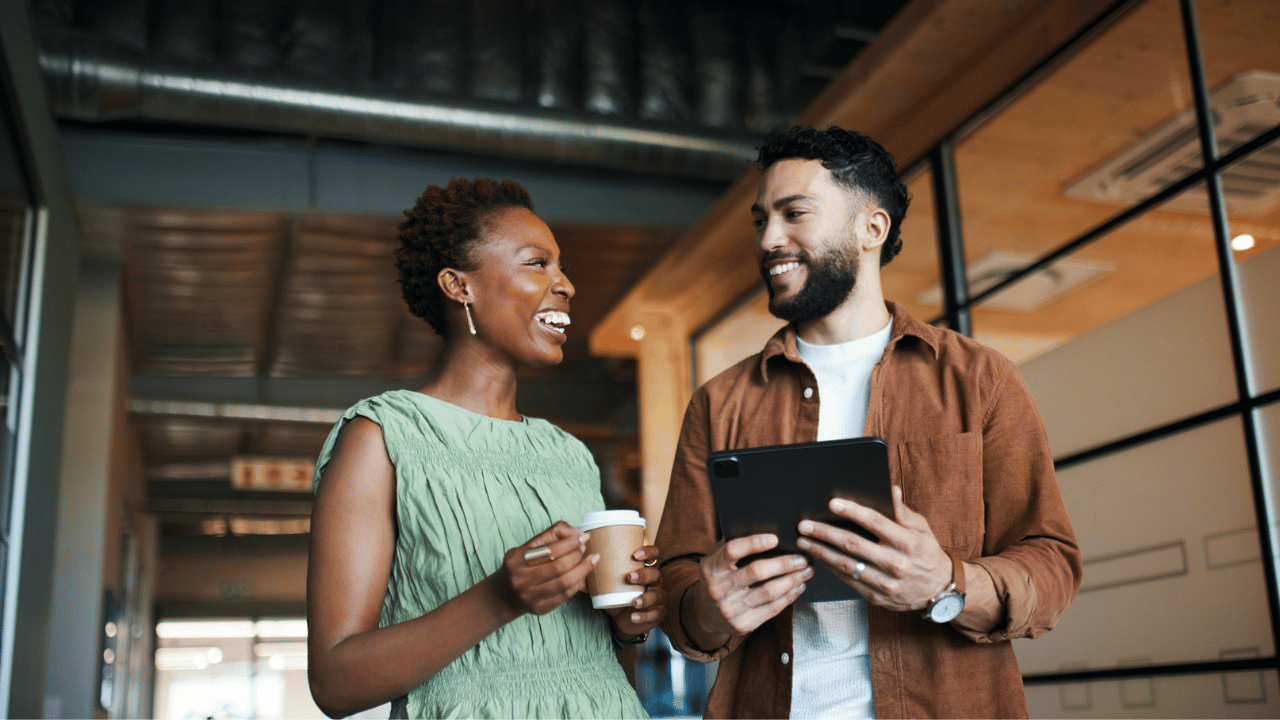 Image depicts two payroll leaders discussing payroll automation.