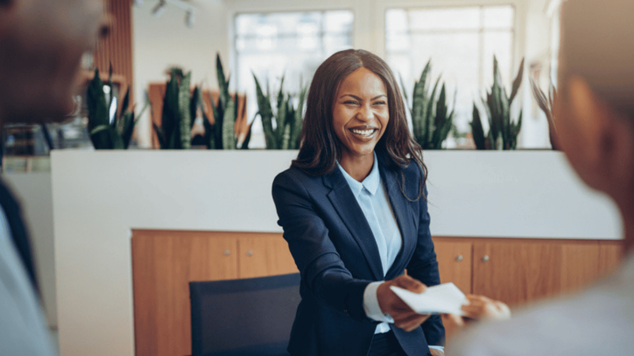 Image depicts an employer handing off a check that has been approved for net pay accuracy