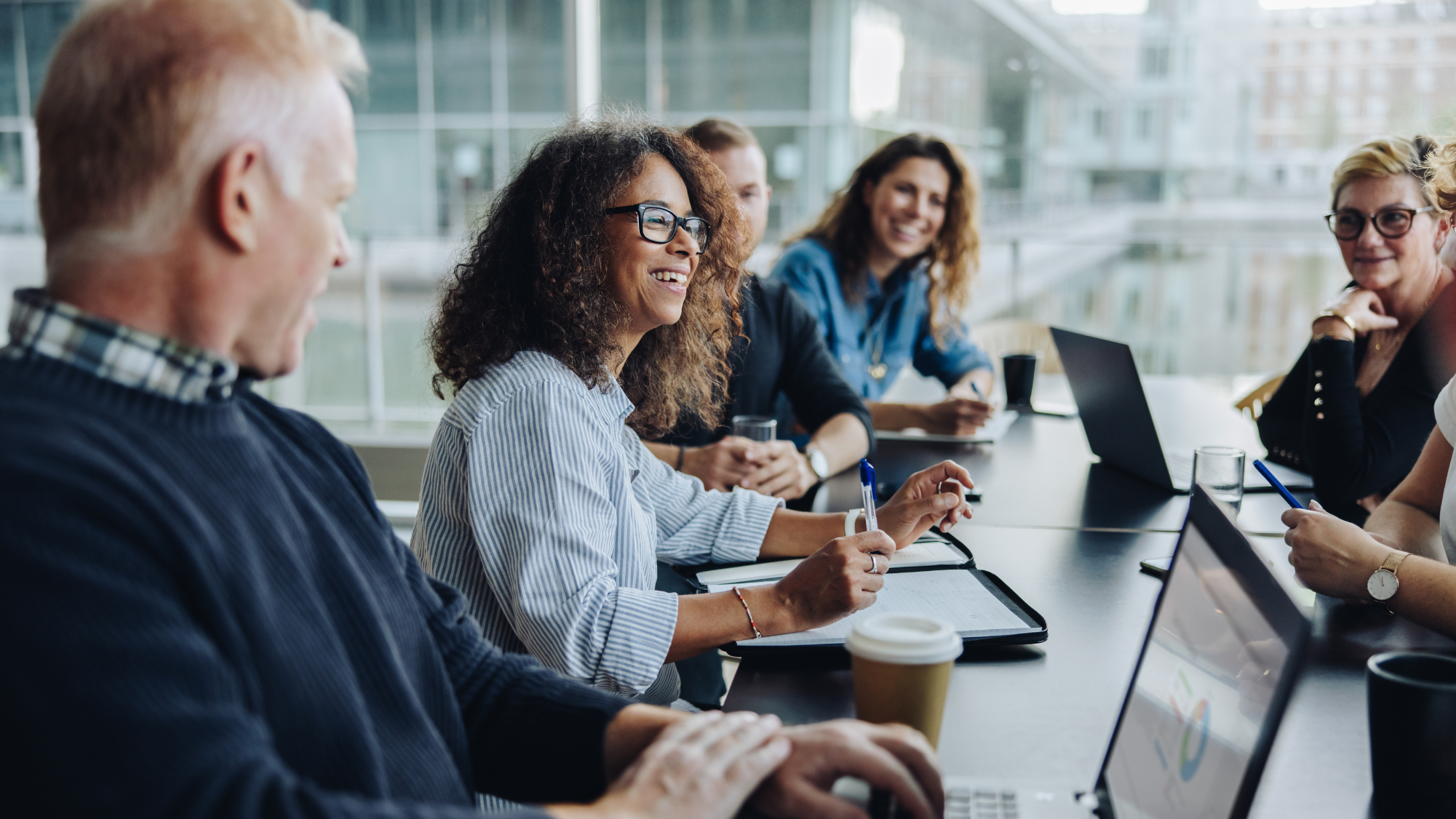 Image depicts HR professionals discussing benefits management