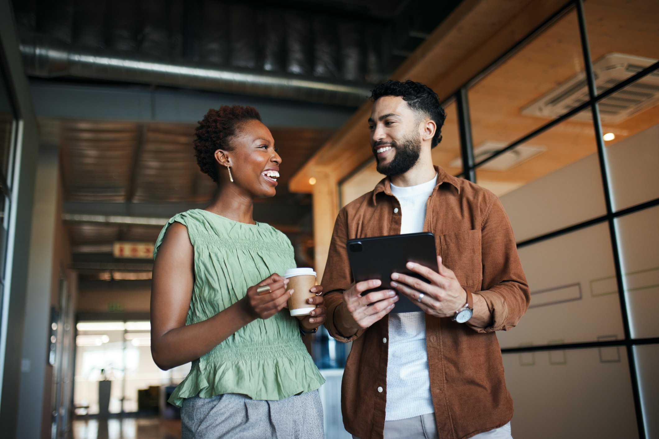 Image depicts two payroll leaders discussing payroll automation.