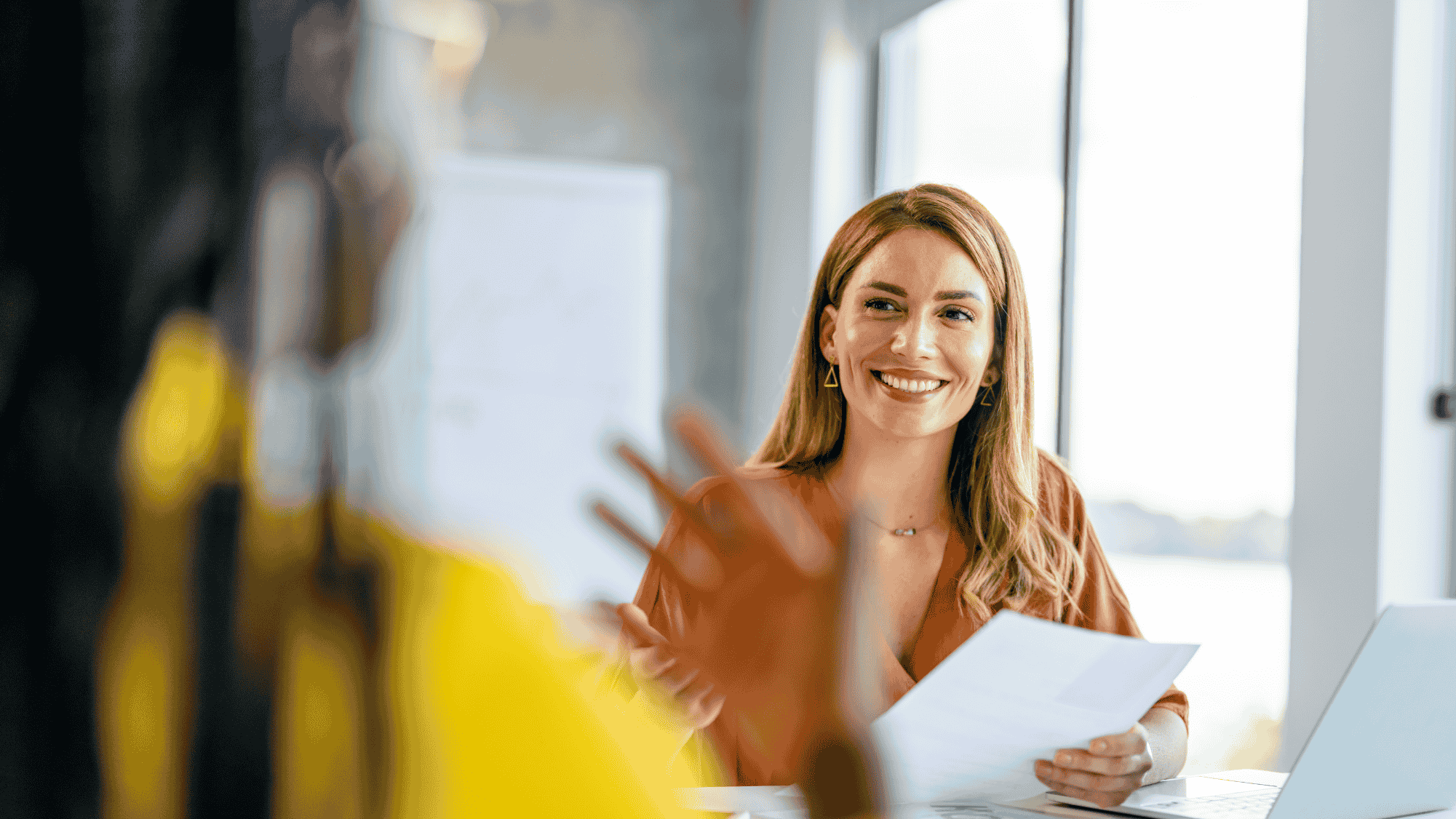 Image depicts an payroll professional discussing their payroll administration