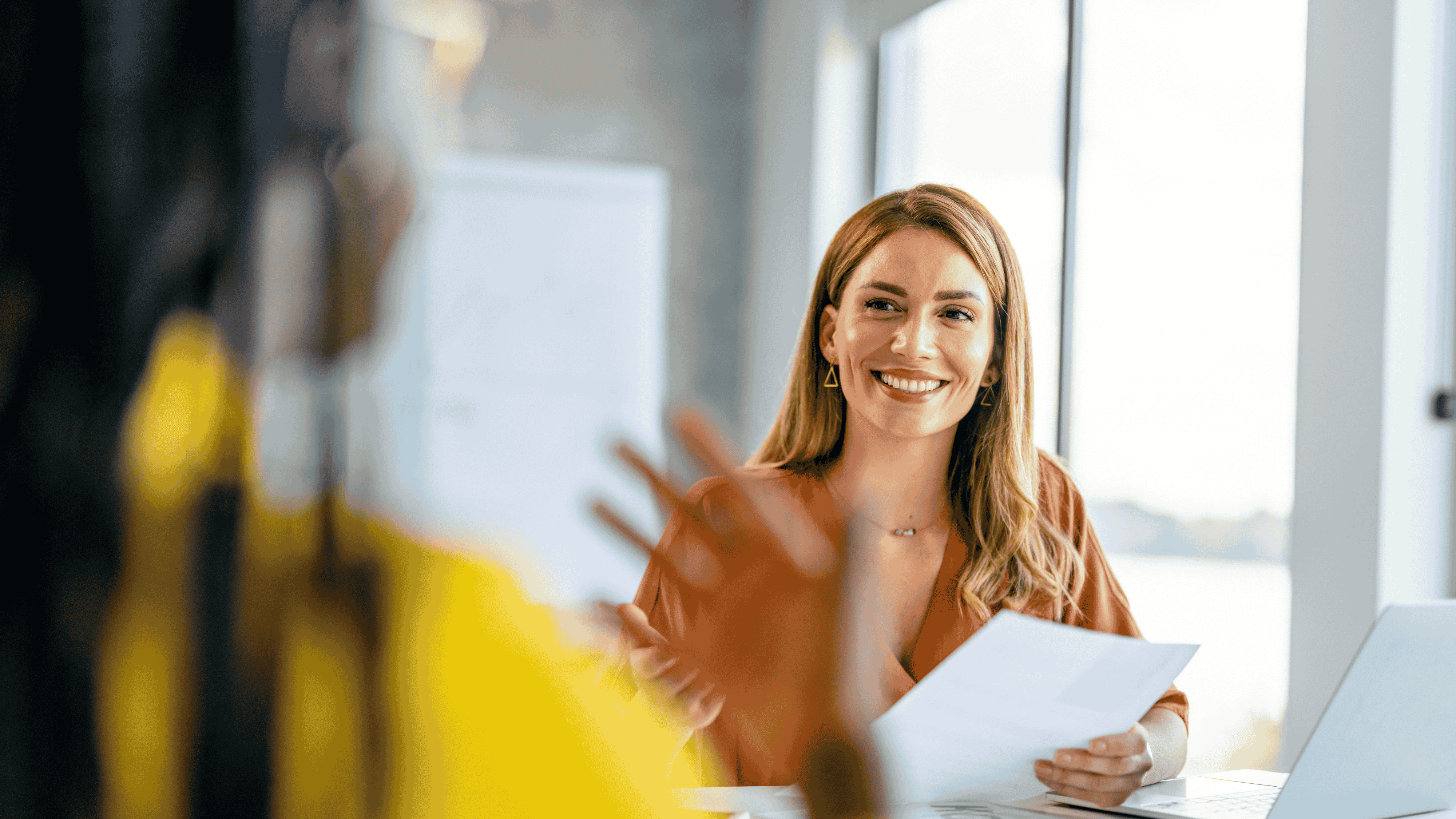 Image depicts an payroll professional discussing their payroll administration